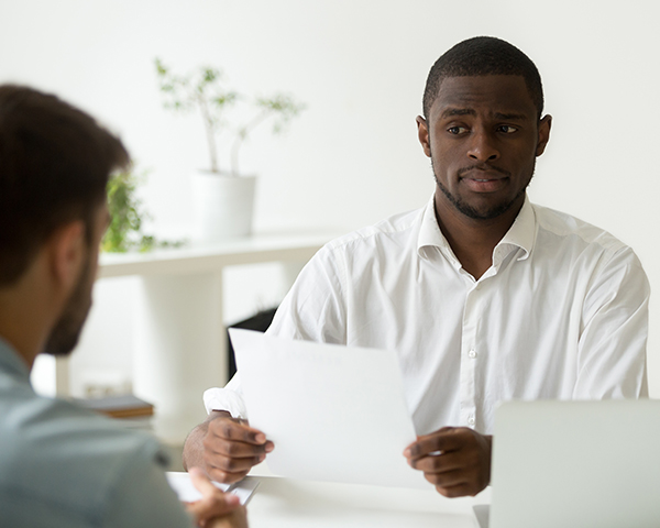 apprehensive african american man supervisor screens interview candidate