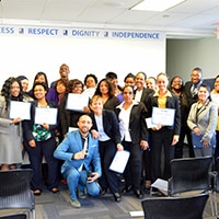 The first group of graduates from Goodwill of Greater Washington's hospitality program for the LINE hotel in Washington DC pose at their graduation with their diplomas