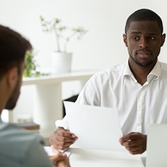 apprehensive african american man supervisor screens interview candidate