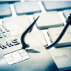credit card on fish hook phishing scam stock image