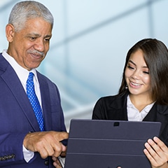 mature business man shares tablet with coworker