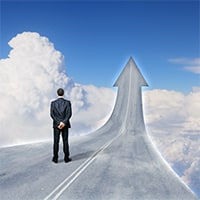A man standing on a road in the sky that turns into an arrow pointing up