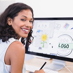 woman graphic designer sits at a computer
